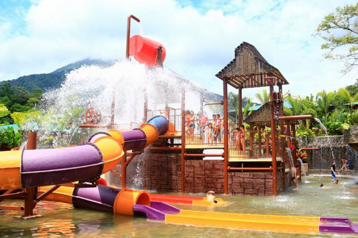 A giant red bucket feature dumps water on revelers.