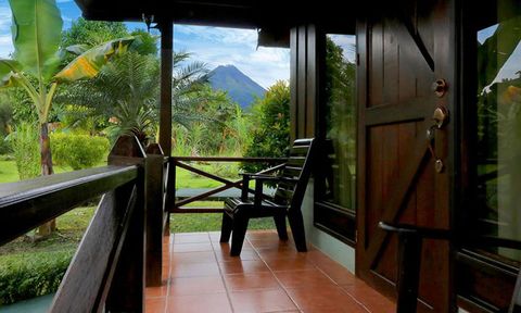 A porch and chair with volcano view at Arenal Montechiari.